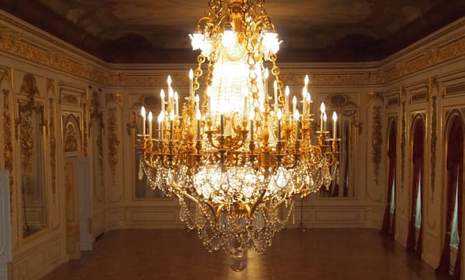 A large chandelier made up primarily of crystals hangs from the ceiling. 