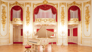 A photo of the grand piano in the Hagoromo no Ma. A gold and white piano stands in the middle of the grand room, in front of a white wall intricated decorated in gold, with an orchestra box with red curtains.