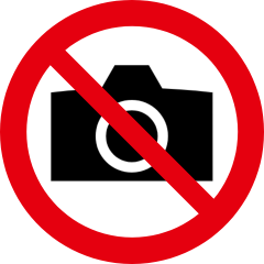 Un pictograma de un teléfono inteligente con el icono de una cámara en un círculo rojo tachado con una línea roja.