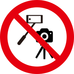 A pictogram of a selfie stick and a camera mounted on a tripod in a red circle crossed through with a red line.