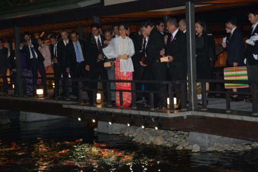 H.E. Ms. Aung San Suu Kyi, State Counsellor of the Republic of the Union of Myanmar is feeding Koi carp.