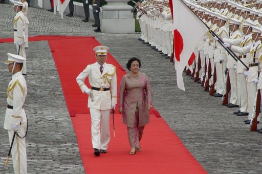 President Megawati walks on the red carpet led by a commanding officer during the welcome ceremony in the front garden