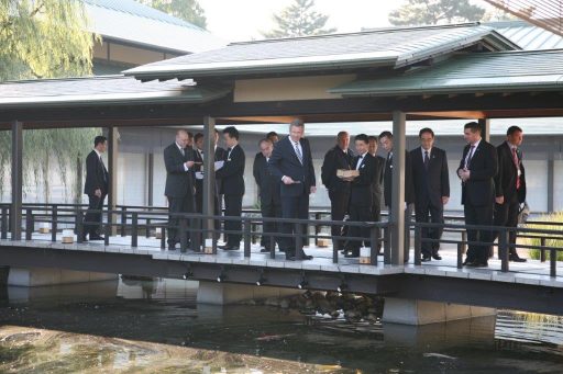 H.E. Mr. Christian Wulff, President of the Federal Republic of Germany appreciating the feeding of the koi carp from the covered bridge.