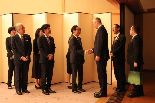 President greeted in a receiving line.